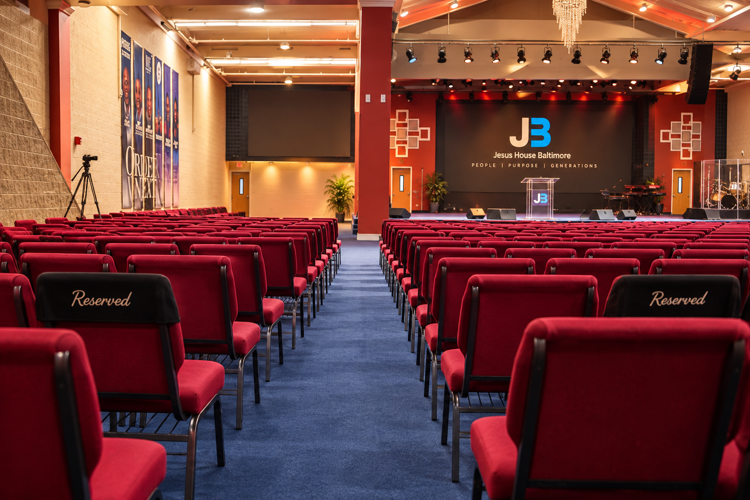 Jesus House Baltimore sanctuary interior with red seating and stage
